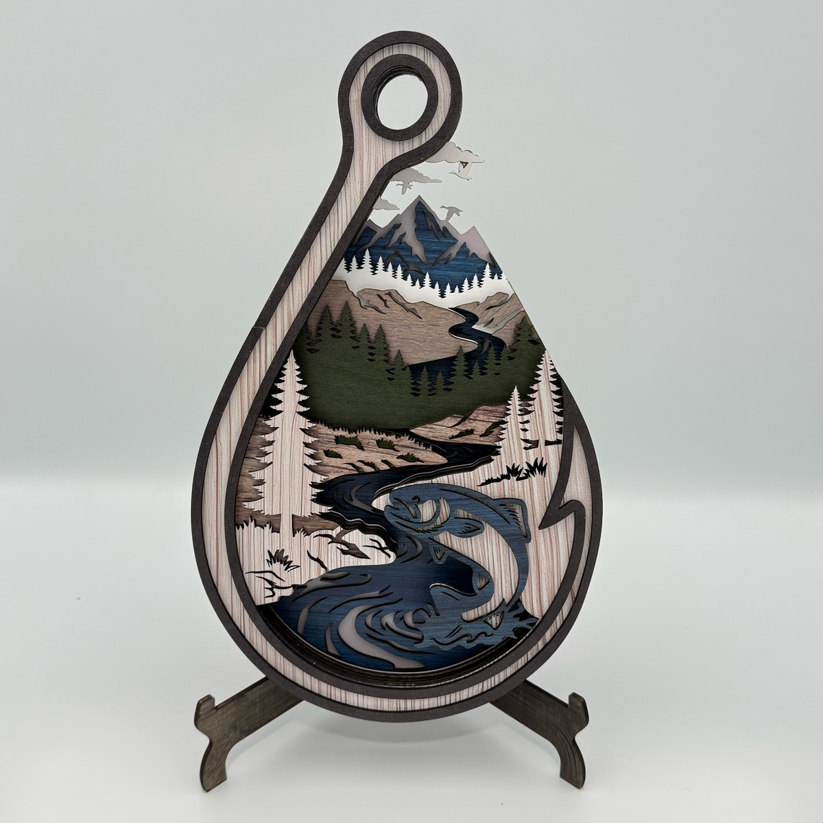Layered fishing hook wooden art with fish and river