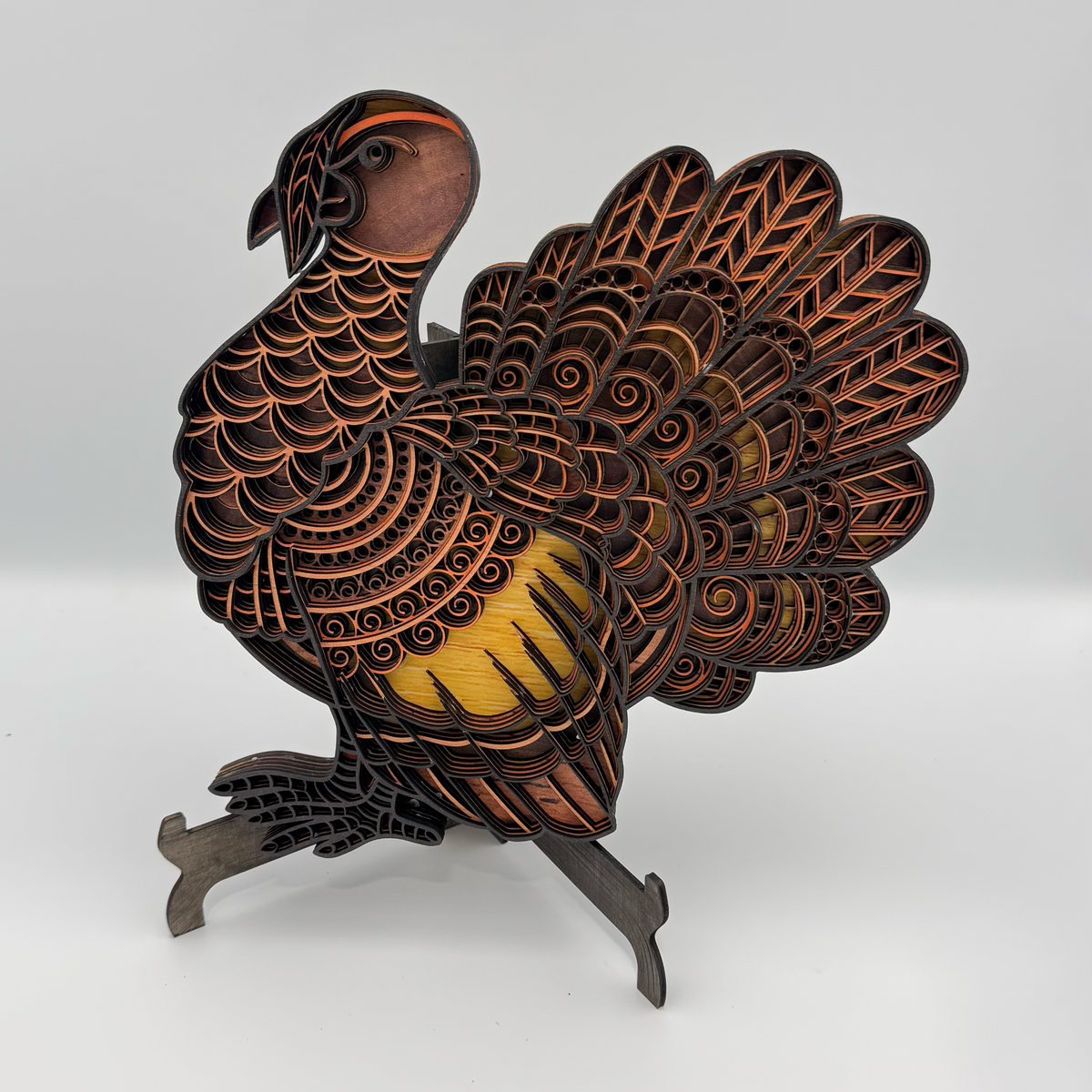 Layered wooden turkey with intricate fan feathers